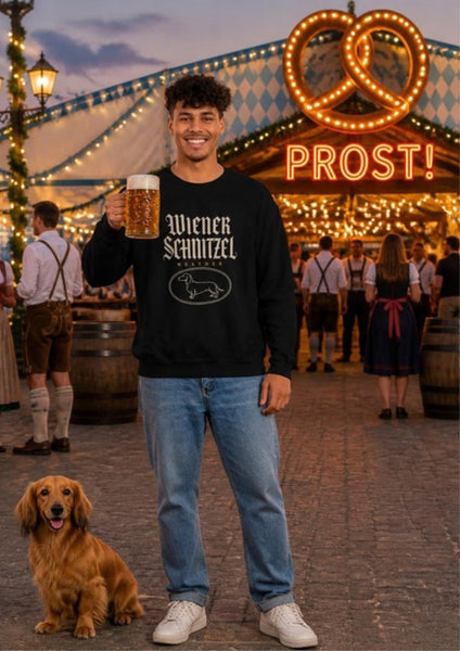 Man wearing the Wiener Schnitzel Weather crewneck, smiling and holding a beer stein next to a dachshund at an Oktoberfest pretzel stand